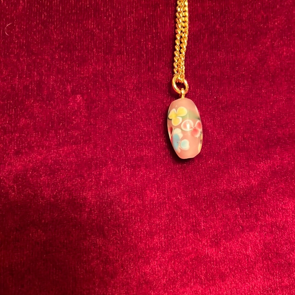 2/15 Vintage pink millefiore bead on a gold tone necklace